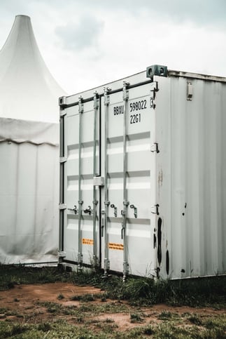 A white shipping container used for event storage